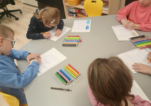 Grupa Biedronek wykonuje prace plastyczą z okazji Dnia Kredki