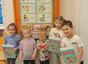 Na zdjęciu widać piątkę dzieci, które pozują z książkami.